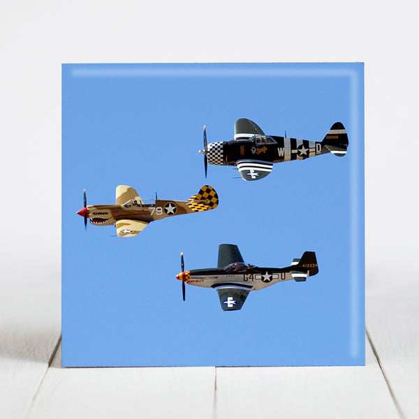 A P-40 Warhawk, P-51 Mustang, P-47 Thunderbolt and P-38 Lightning fly in Heritage Flight
